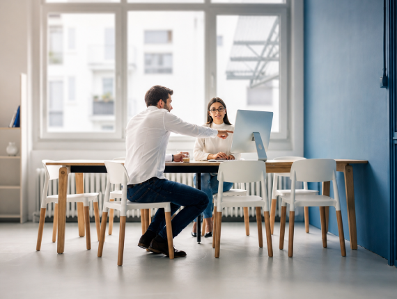 Coworkers collaborating at a laptop